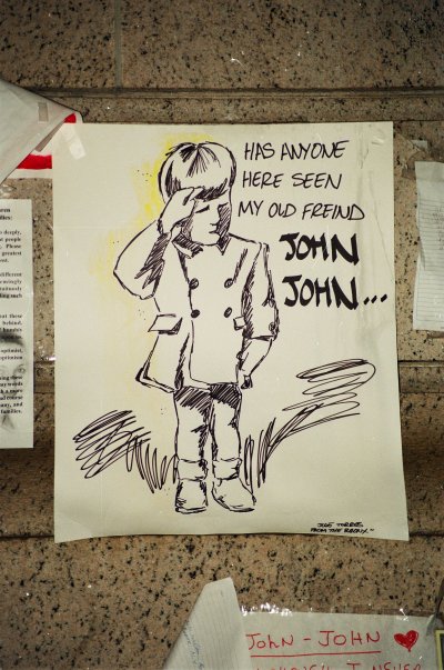 A drawing of three-year-old JFK Jr. saluting his father's coffin, placed on a memorial wall for him shortly after his death