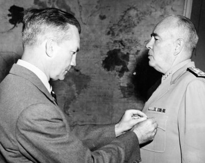 Secretary of the Navy Forrestal pins Admiral Jonas H. Ingram with a Gold Star in lieu of a third Distinguished Service Medal on May 21, 1946.